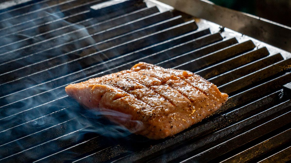 Salmon fillet cooking on a barbecue